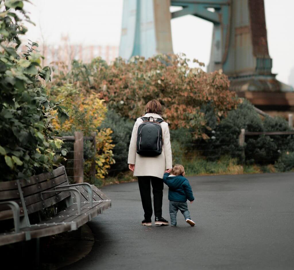 Busy Mum walking with their child