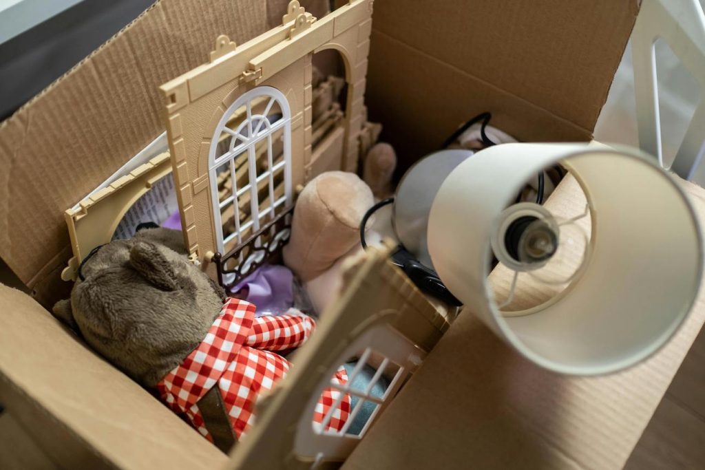 kids toys and items being packed into a box
