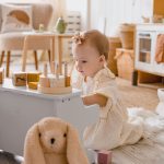 child playing with a little toy in their room