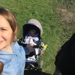 lady smiling and baby in pram